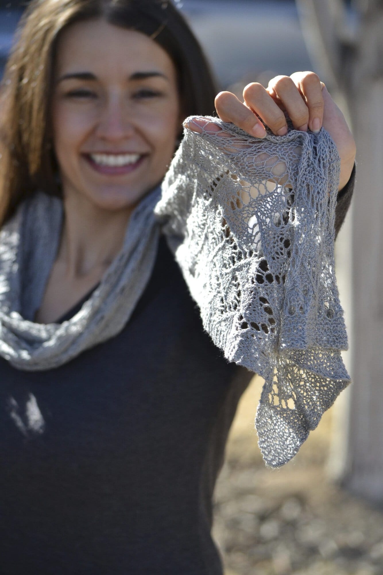 Close-up of the Offset Lace stitch pattern in the Shangri-La free knit lace shawl scarf pattern, sunlight through the lace.