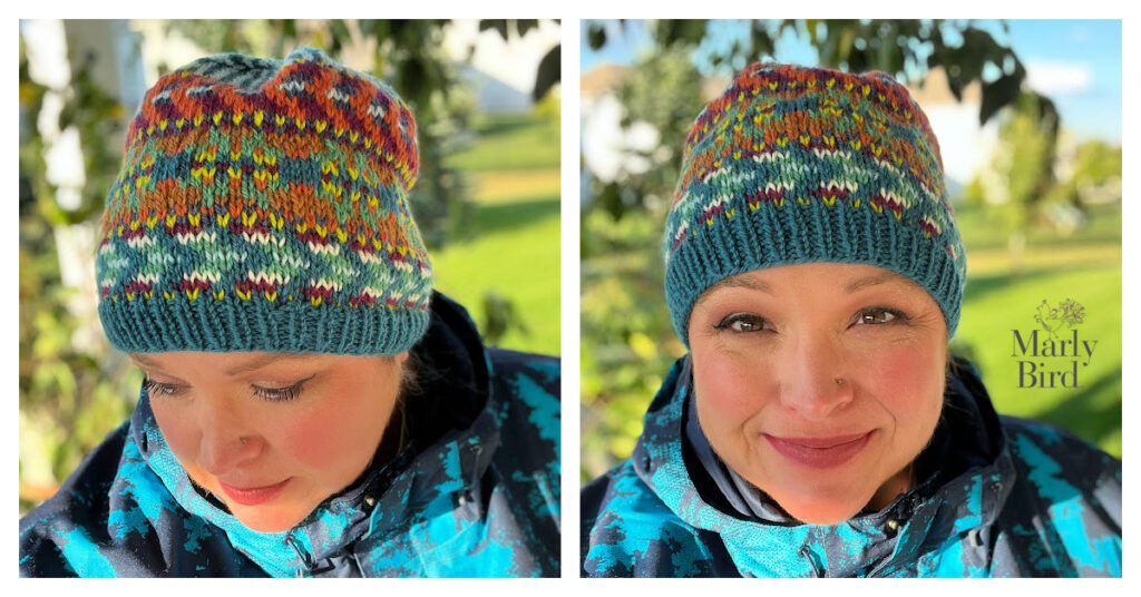 The image is a side-by-side collage of two photos featuring a person wearing a hand-knit hat, known as the "Kaleidoscope Harmony Hat." The hat showcases a vibrant, multicolored pattern with intricate designs reminiscent of a kaleidoscope, set against a teal ribbed brim. The person is dressed in a matching blue jacket with a patterned design, complementing the hat's colors. In the right photo, the individual is looking towards the camera with a pleasant smile, while the left photo captures a more contemplative expression, gazing downward. The backdrop is outdoors, with blurred greenery that highlights the hat's vivid colors. The Marly Bird logo in the corner indicates that this is a promotional image for a free knitting pattern available from Marly Bird. The hat's colorful and detailed pattern, along with the wearer's content expression, exudes warmth and the cheerful spirit of handmade fashion.