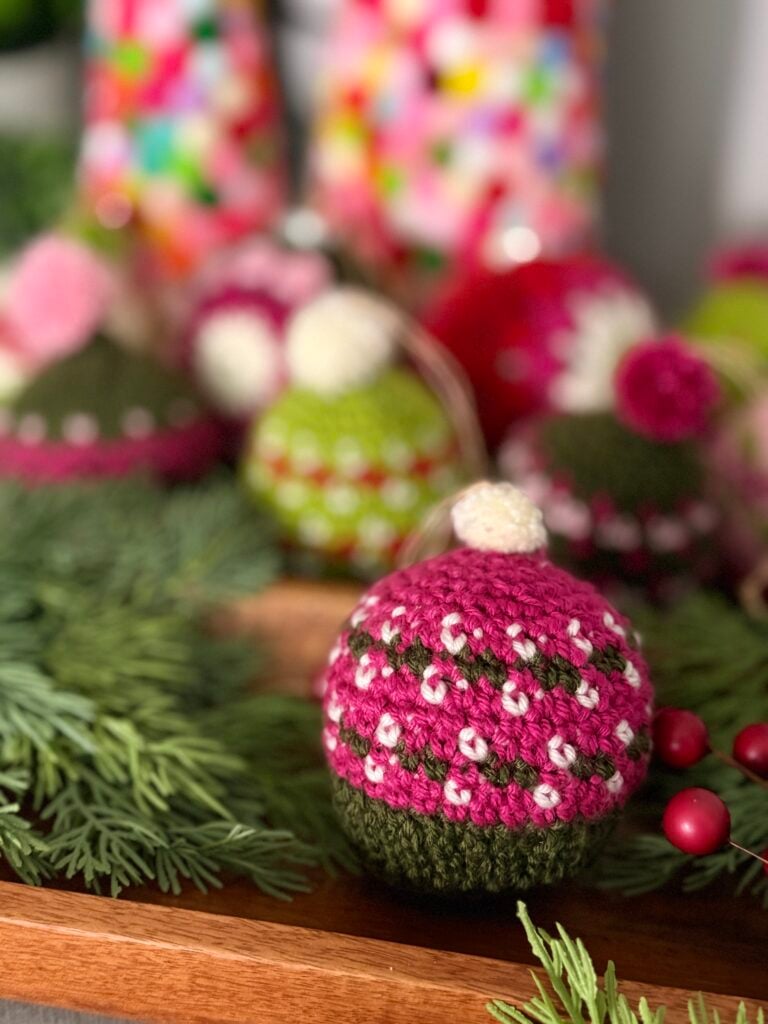 Merry Mischief crochet hat ornament in a pink colorway — free colorwork crochet pattern
