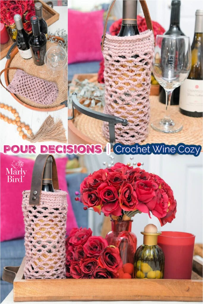 Pink crochet wine cozy with a leather strap on a bottle, detailed stitches visible; surrounded by glasses and red roses.