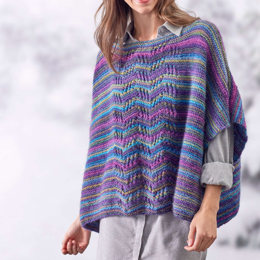 Lace Panel Knit Poncho by Salena Baca - Free Knit Poncho Pattern from Yarnspirations - part of the collection of free knit ponchos on Marly Bird website - poncho is made in unforgettable yarn in purples, pinks and blues 