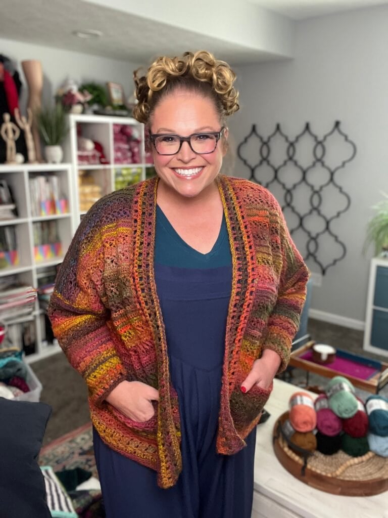 Marly Bird wearing the Sookie Crochet Cardigan in Red Heart Roll With It Mélange Curtain Call, a free crochet cardigan pattern in sizes XS-5X