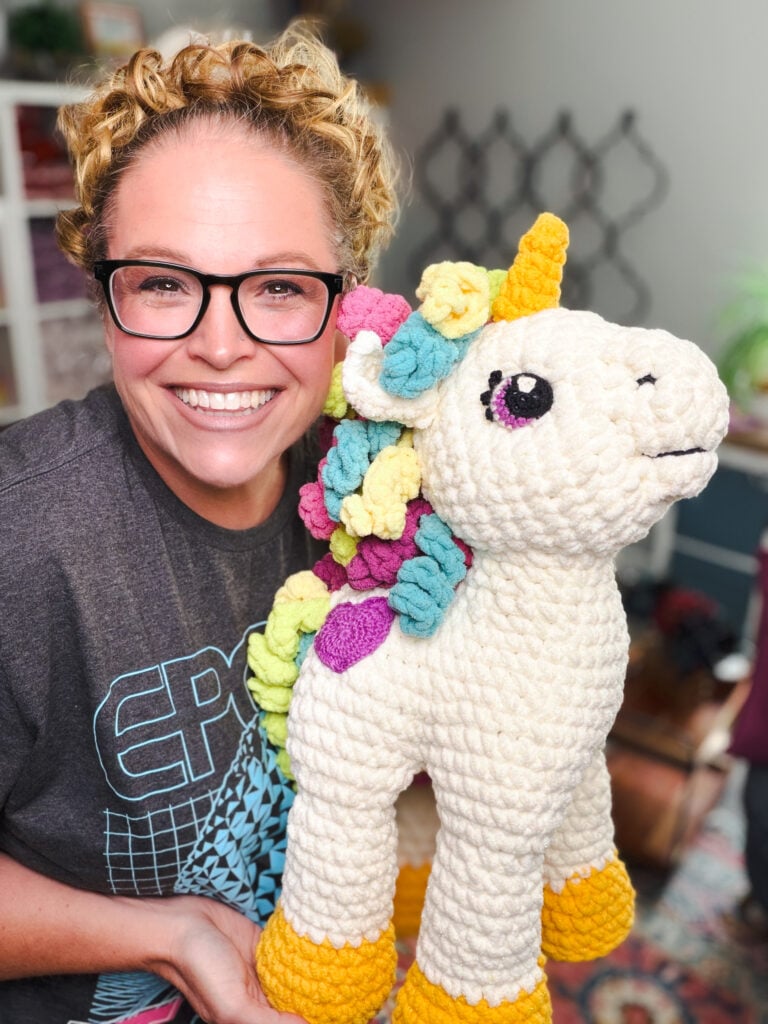 Marly Bird posing cheek-to-cheek with Sparkle the Crochet Unicorn amigurumi — free 20-inch stuffed unicorn crochet pattern