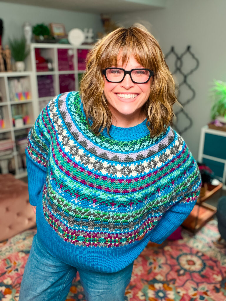 Marly Bird wearing the Spectrum Stitch mosaic crochet swoncho in rainbow colors — free colorwork crochet sweater pattern