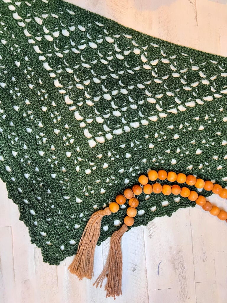 Full triangle shape of crochet beginner shawl pattern showing lace stitch design and drape