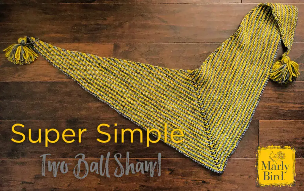 Yellow and gray striped knitted shawl with tassels on each end, shown flat on a wooden floor; labeled "Super Simple Two Ball Shawl.