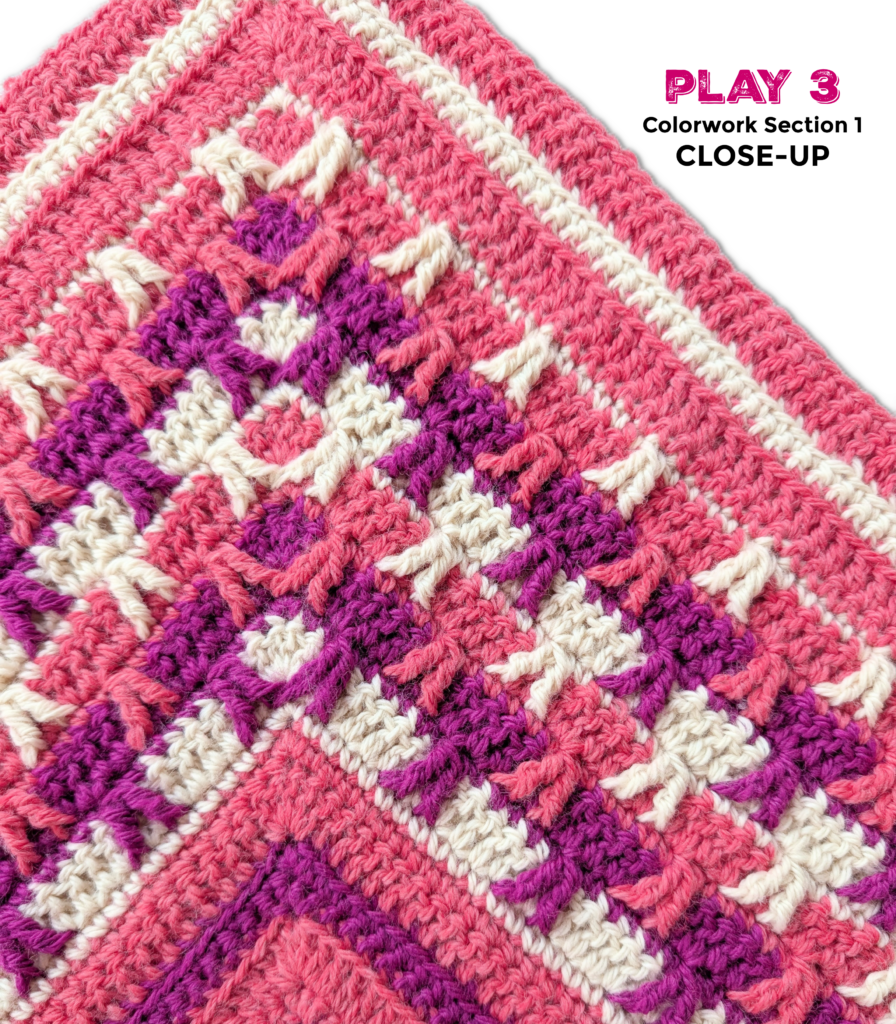 Close-up of a vibrant pink, white, and purple crochet project featuring a textured colorwork stitch pattern.