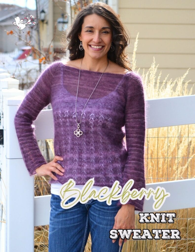 A woman stands outdoors smiling, wearing a purple Boatneck Knit Raglan Sweater Pattern, blue jeans, and a long necklace. The text "Blackberry Knit Sweater" is written on the lower part of the image. -Marly Bird