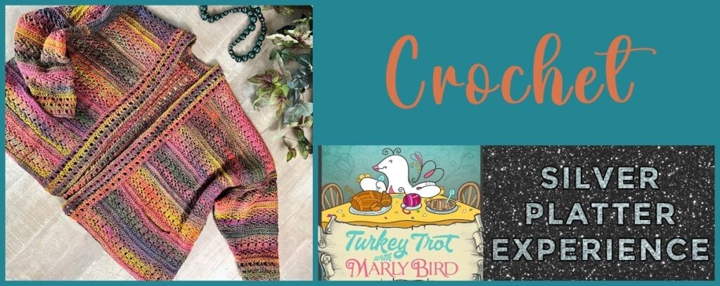 A multicolored crochet cardigan with a matching hood and belt, shown flat with a beaded necklace, features textured stitch detail.