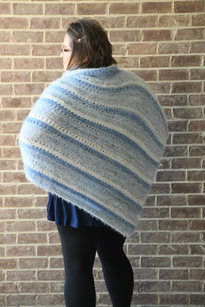 back view of the 2019 turkey trot mystery make-along poncho by Marly Bird. Showing off the drop knit stitches. 