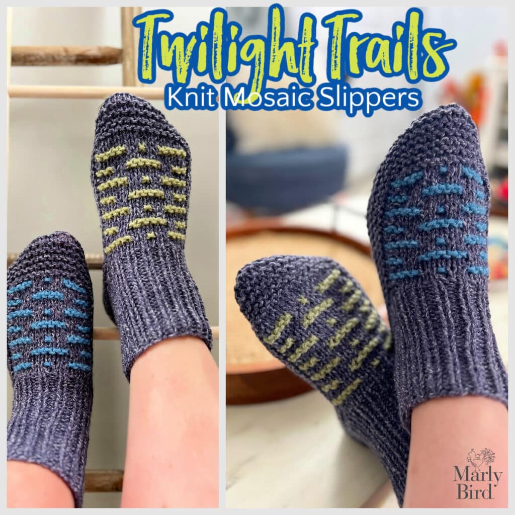 Close-up of a person wearing knit mosaic slippers. The left slipper boasts a green pattern, while the right displays a blue design on gray. Embrace cozy comfort with "Twilight Trails Knit Mosaic Slippers" by Marly Bird, adding a pop of color to your relaxation moments. -Marly Bird