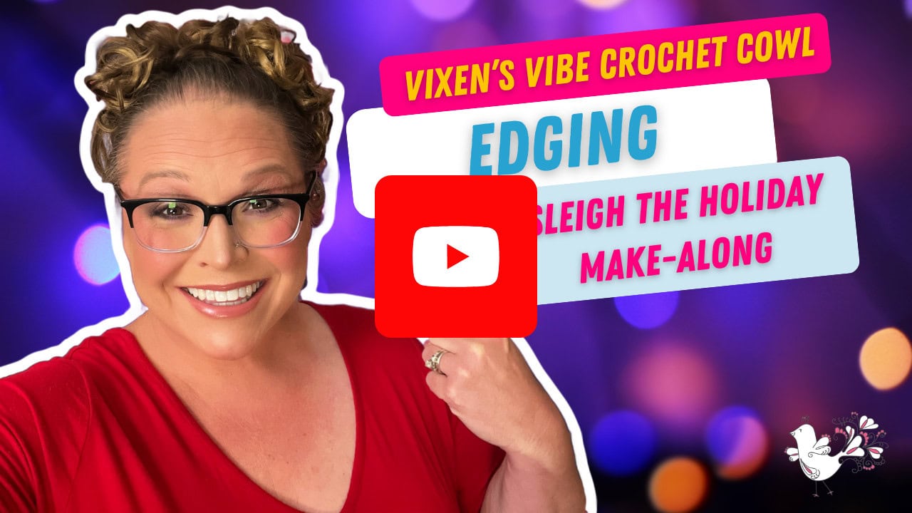 Smiling woman with glasses and braided hair points at text reading “Vixen’s Vibe Crochet Cowl Edging Sleigh the Holiday Make-Along,” inviting viewers to join this festive crochet make-along, on a colorful bokeh background with a YouTube play button overlay. -Marly Bird