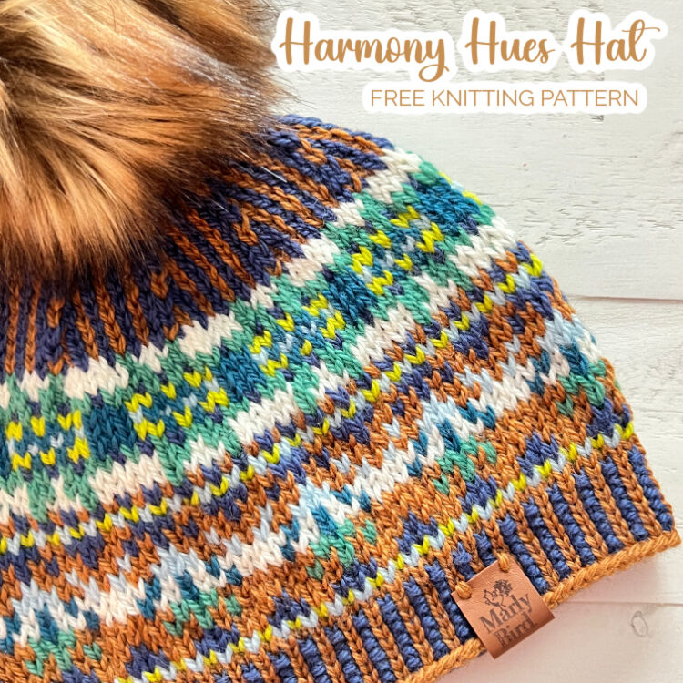 HARMONY HUES HAT ON A TABLE WITH A BROWN FAUX FUR POM - Marly Bird