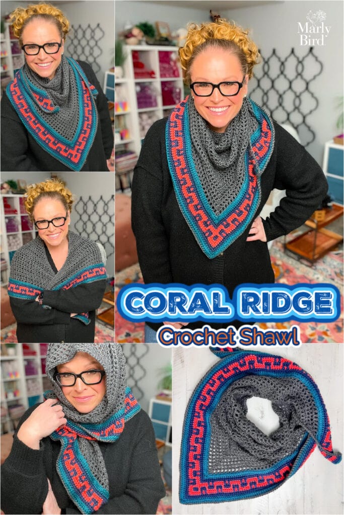 Woman models a gray crochet shawl with blue and coral trim, showing triangle shape and detailed edging. Coral Ridge Shawl.