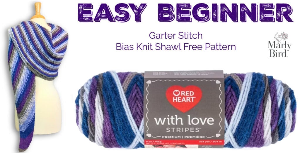 Striped knit shawl in blue, purple, and white draped on a mannequin; skein of Red Heart With Love Stripes yarn below.