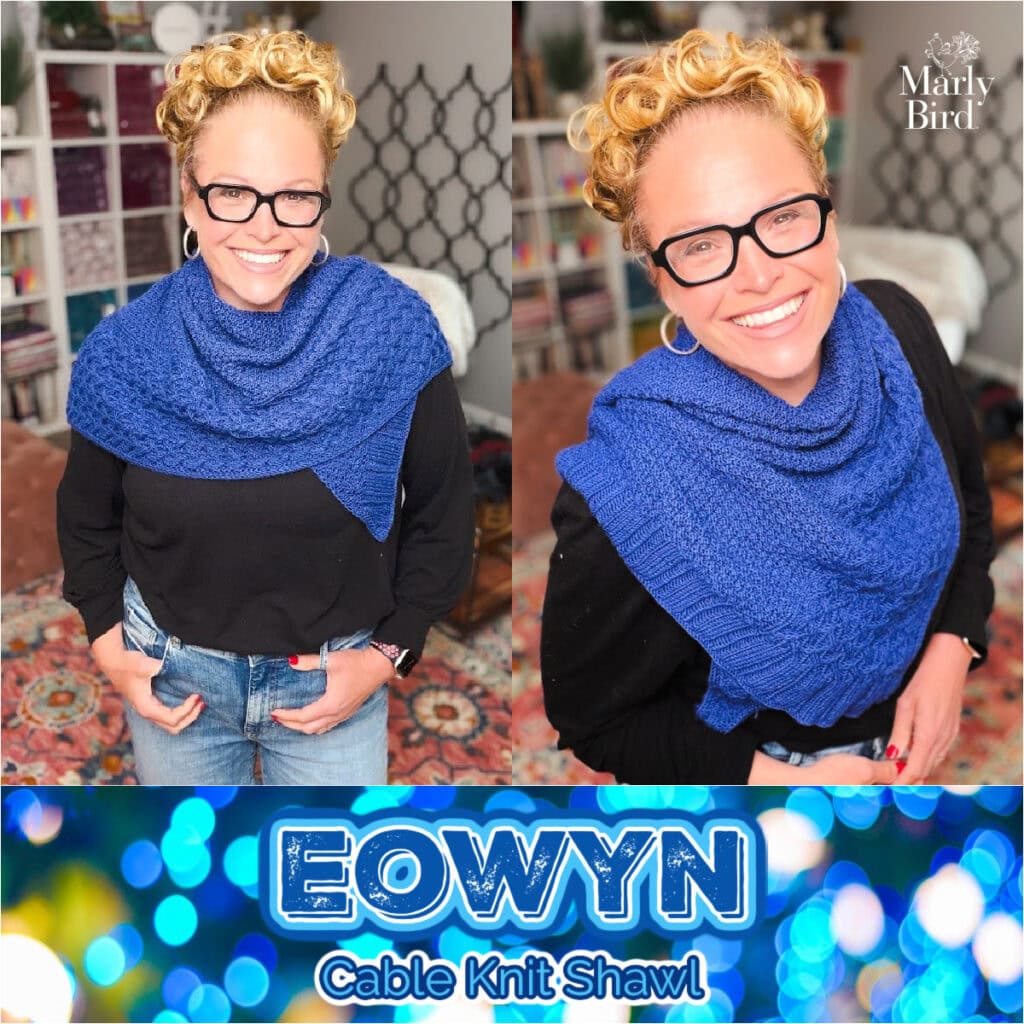 Woman models a blue cable knit shawl, showing its textured stitch detail in a cozy room with bookshelves and decor.