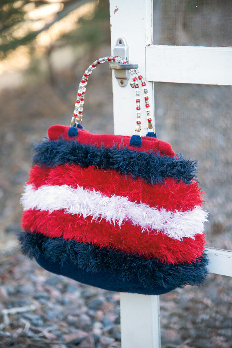 Firecracker felted crochet purse - free pattern - red, white and blue eyelash yarn is worked together with 100% wool and felted to make a sizeable handbag - decorated with a beaded handle for a little something extra - marly bird