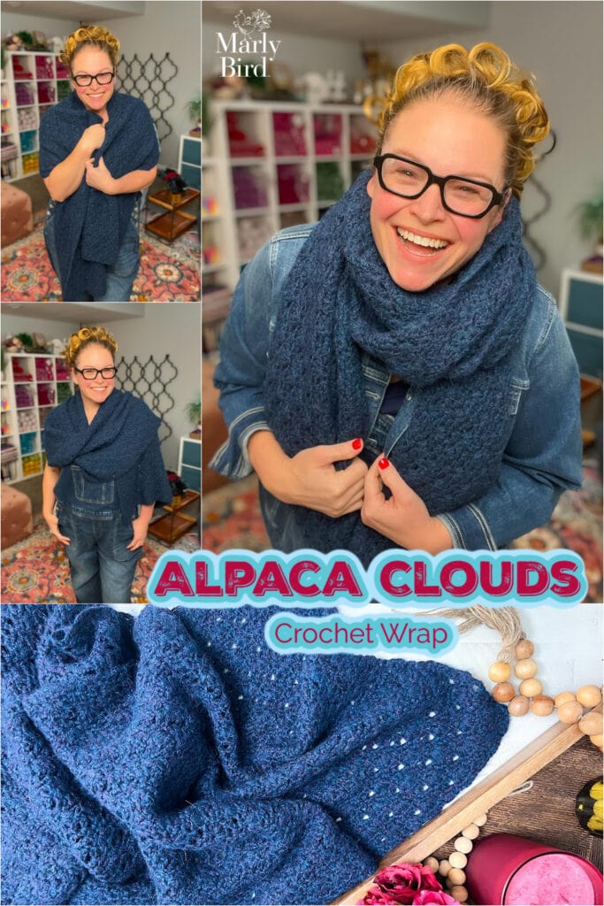 A woman with glasses wears a navy blue crochet wrap, showing lace stitch detail and soft texture; craft supplies are nearby.