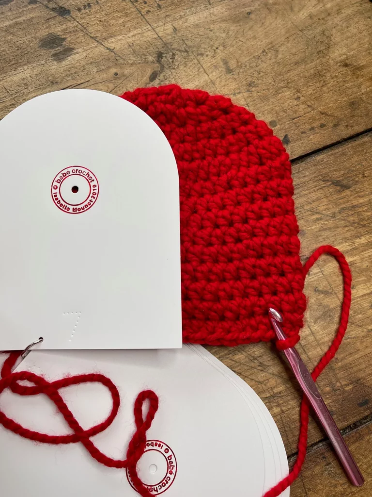Crochet hat templates on a red crochet hat with a crochet hook - Marly Bird
