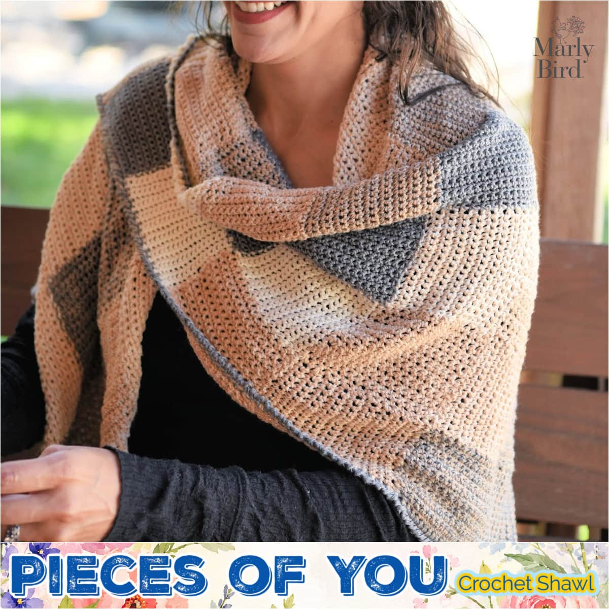 Woman on bench wears a crochet entrelac shawl in beige, gray, and cream blocks, showing textured stitches and soft drape.