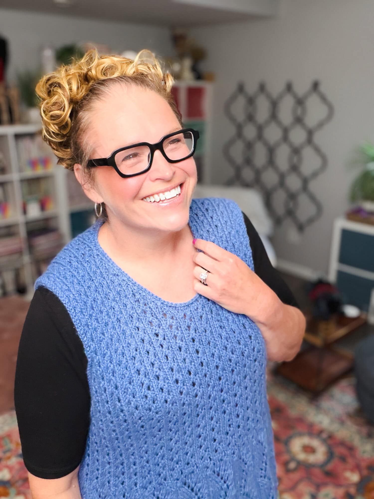 Marly Bird wearing the Thistlevine free knit tunic vest pattern in a studio lifestyle shot, showing the front silhouette of the sleeveless knit lace tunic over a fitted collared top