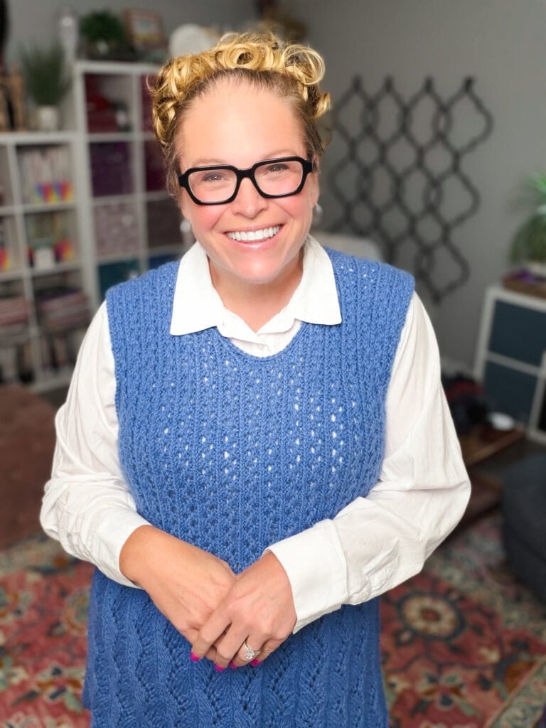 Thistlevine free knit tunic vest pattern styled over a white button-down shirt by Marly Bird, demonstrating how to layer the sleeveless lace tunic for fall and spring